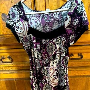 Purple blouse with tan, black, and white patterns.